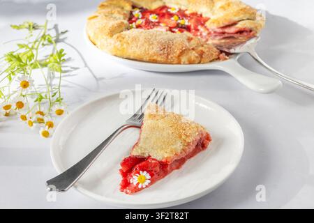 Slice of rustic strawberry galette on a plate Stock Photo