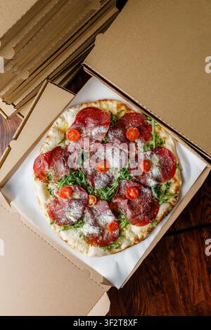 Craft pizza on delivery boxes, isolated. Professional studio lighting Stock Photo
