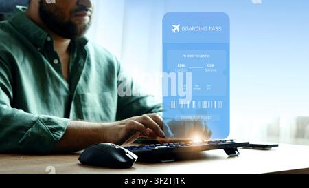 Booking travel online for a flight from London to Geneva with a boarding pass displayed on the screen Stock Photo