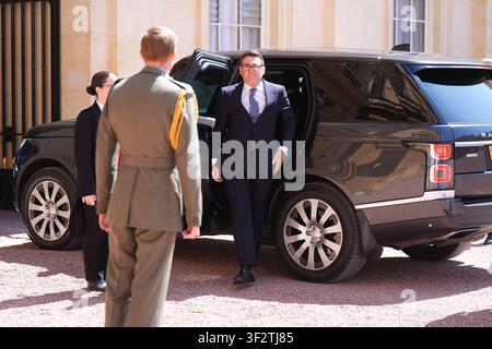 King Charles III's Equerry, Major Ben Rigby (left) greets Labour Party leader Andy Burnham as he arrives at Buckingham Palace, London, for an audience with King Charles III where he will be invited to become Prime Minister and form a new government. Picture date: Monday July 20, 2026. Stock Photo