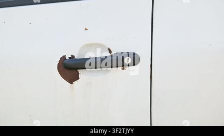 Rusty Car Door Handle on White Vehicle Close Up Stock Photo