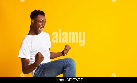 Portrait of handsome african guy showing breakthrough gesture Stock Photo