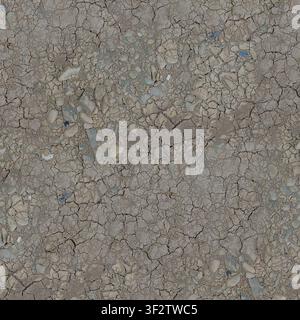 An overhead view of parched, cracked mud and dry clay ground embedded with small grey river stones. Stock Photo