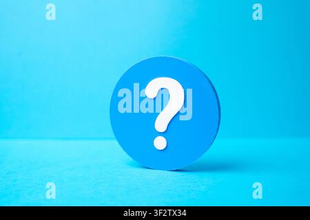 A question mark in a blue circle. FAQ and surveys. Ask a question. Get information. User support concept, inquiry culture, feedback channels and knowl Stock Photo