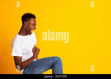 Excited young african man gesturing and celebrating victory Stock Photo
