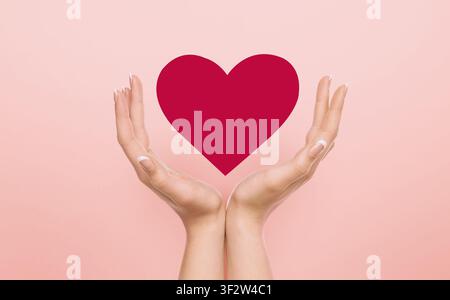 Volunteering concept. Female hands guarding red heart over pink background, collage Stock Photo