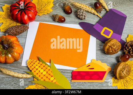 Thanksgiving flat lay background featuring festive elements and a blank orange message card Stock Photo