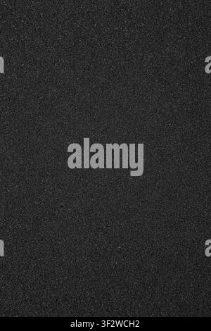 Texture of black synthetic sponge foam rubber sheet close up background. Stock Photo