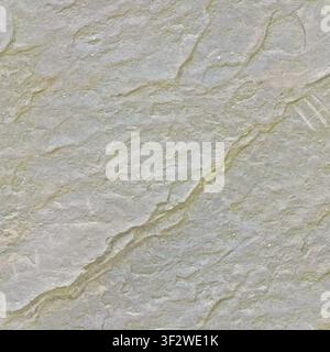 A clean, light grey and tan sandstone surface featuring a prominent diagonal crack with subtle green lichen growth. Stock Photo
