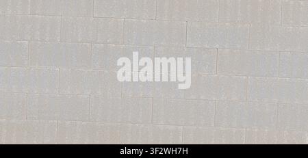 A running bond pattern of light gray concrete blocks forming a clean masonry wall. Stock Photo