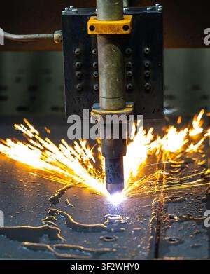 CNC laser cutting machine processing sheet metal with bright sparks Stock Photo