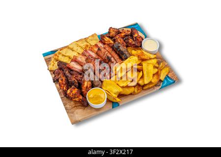 Assorted BBQ Meat Platter with Chicken Wings, Sausages, Ribs, Potato Wedges and Sauces. Stock Photo