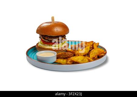 Chicken Burger with Potato Wedges and Creamy Dipping Sauce on Blue Plate Stock Photo
