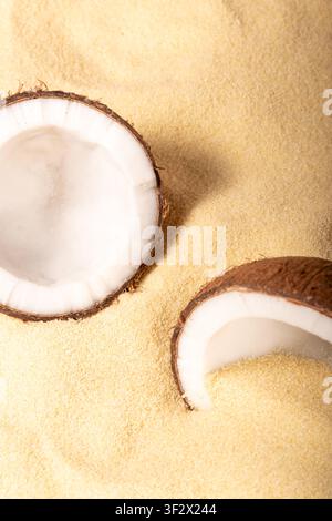 Cracked coconuts on sandy beach. Minimal summer tropical concept. Stock Photo