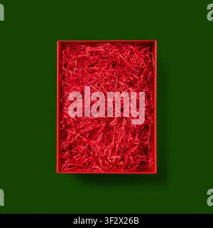 Open Red Gift Box on green background. Stock Photo