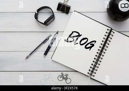 Smartwatch and notebook with word BLOG on office desk, copy space. Creative collage Stock Photo