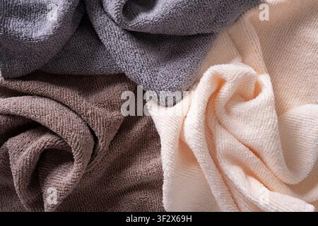 Soft microfiber towels in gray cream and brown colors. Household textile background for cleaning and bathroom concepts. Stock Photo