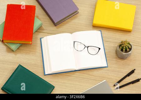 Opened book close up with glasses and cactus Stock Photo