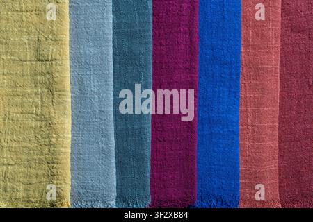 Assortment of multi colored organic linen or cotton textile swatches arranged in vertical lines, close up. Canvas woven material fabric palette backgr Stock Photo