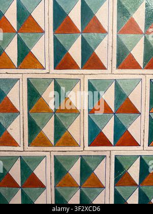 Geometric pattern on colorful tiled surface, ideal for backgrounds with vibrant designs. Mobile photo Stock Photo