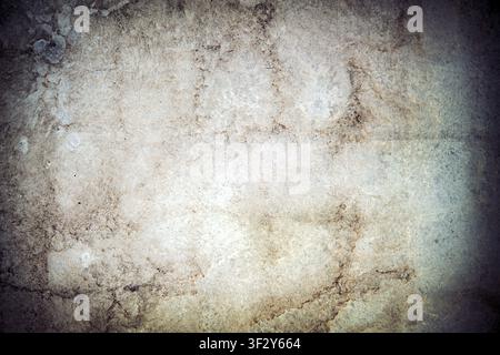 Close-up of a worn concrete wall featuring distressed texture and natural weathering. Industrial backdrop ideal for architecture and design concepts. Stock Photo