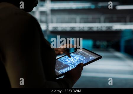 Close up of data center computer scientist conducting tests on gear using AI to fix bugs. Server hub worker uses machine learning to refine algorithms for faster processing, updating core services Stock Photo