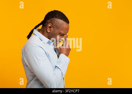 Pensive mature african american man deep in thoughts Stock Photo