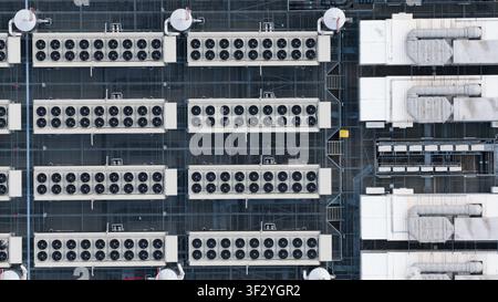 Aerial view of rooftop cooling systems on large data centers in Slough, showing cloud infrastructure, power demand and digital technology near London. Stock Photo