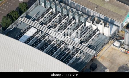 Aerial view of rooftop cooling systems on large data centers in Slough, showing cloud infrastructure, power demand and digital technology near London. Stock Photo