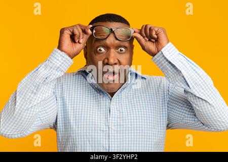 Shocked mature african american man looking at camera Stock Photo