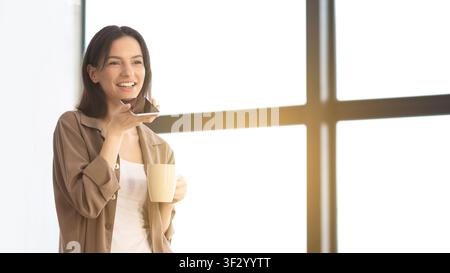Young woman using mobile voice recognition function Stock Photo