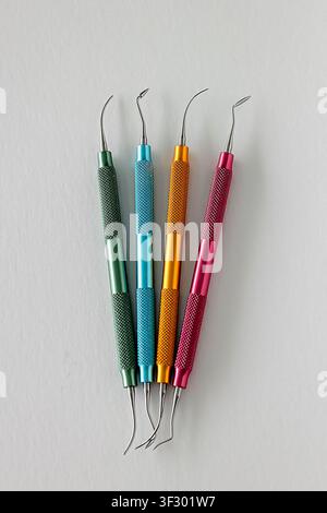Color coded dental composite modeling instruments on white background Stock Photo