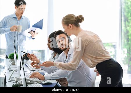 Team of call center operators at work in open space office Stock Photo