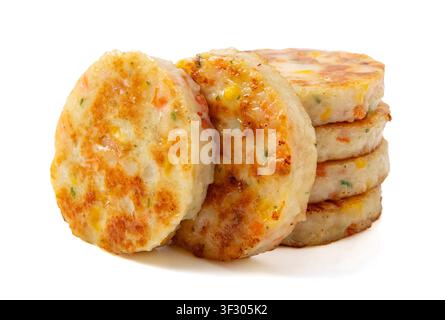 Stack of golden pan-fried fish and shrimp patties isolated on white background. Stock Photo