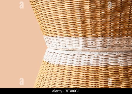 Woven rattan texture with natural and white painted sections, abstract background for design and decor, this abstract background highlights the intric Stock Photo