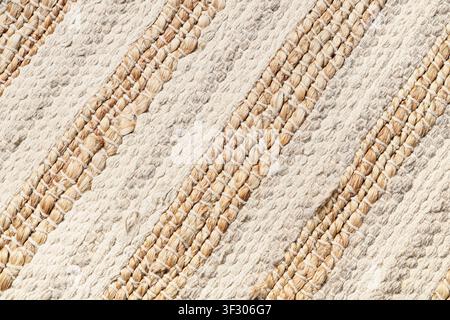 Handwoven natural fiber rug with diagonal stripes, textured background for home decor and textile design Stock Photo