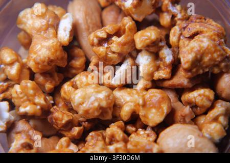 Popcorn and nuts in a bowl for snack time Stock Photo