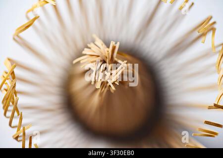 High-angle macro shot of a traditional Japanese bamboo matcha whisk, showing intricate details of the tines and central core. Ideal for tea ceremony a Stock Photo