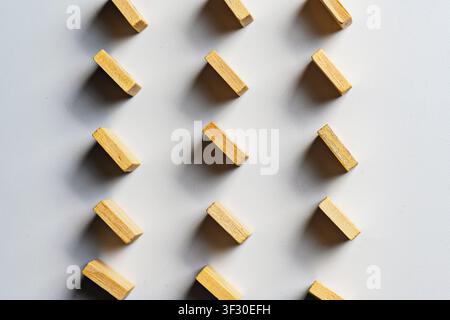 High-angle view of small wooden rectangles arranged in a diagonal grid pattern on a clean white surface. Perfect for background, design concepts, and Stock Photo