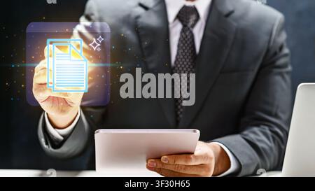 Professional businessman interacts with a glowing digital document icon using a tablet, illustrating paperless office solutions, cloud storage, and mo Stock Photo