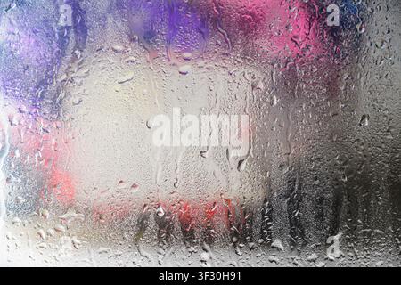 A close-up view of a gray painted surface featuring vertical liquid streaks and drips, creating a grunge industrial background for design projects Stock Photo