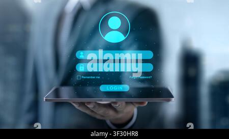 Cybersecurity and digital identity concept with a businessman holding a tablet displaying a virtual login interface for secure access and data protect Stock Photo
