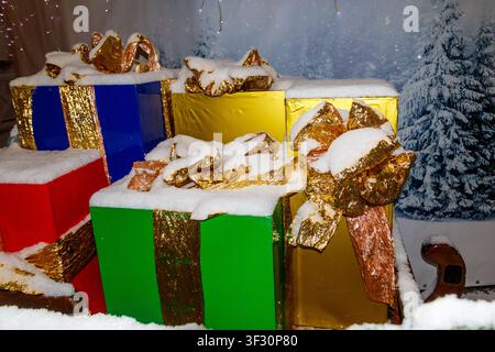 Big Christmas gift boxes covered with white snow Stock Photo