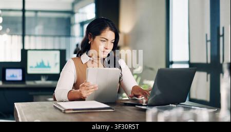 Woman, tech and report in office with feedback, proposal or graphs for market research agency. Female person, laptop and consultant with tablet for Stock Photo