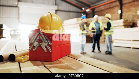 Helmet, workshop and toolbox with men for carpentry, construction project and building. Site, contractor and hardhat for safety, compliance and ppe Stock Photo