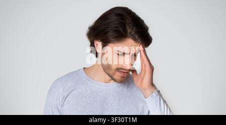 Sick man suffering from headache at home Stock Photo