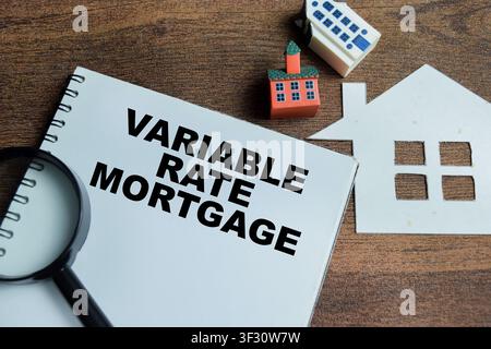 Concept of variable rate mortgage write on book isolated on Wooden Table. Stock Photo