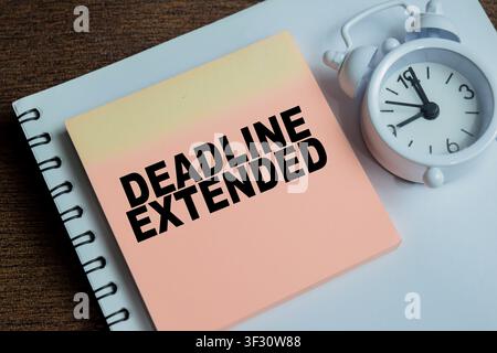 Concept of deadline extended write on sticky notes isolated on Wooden Table. Stock Photo