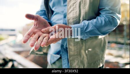 Man, hand pain and construction worker on site with injury, arthritis or accident on duty with inflammation. Contractor, carpal tunnel and civil Stock Photo