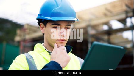 Man, engineer and thinking with tablet at construction site, project planning or safety evaluation. Male person, problem solving and architect with Stock Photo